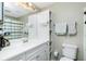 Bathroom with updated vanity, toilet, and linen storage at 4657 Nele St, North Port, FL 34287