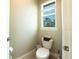 Powder room with toilet and single vanity at 5435 Montego Ln, Port Charlotte, FL 33981