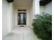 Modern glass front door entryway with plants at 5435 Montego Ln, Port Charlotte, FL 33981