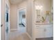 Light hallway with wood-look floors, offering views of a bedroom and bathroom at 5435 Montego Ln, Port Charlotte, FL 33981