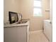 Bright laundry room with utility sink, granite countertop, and washer/dryer at 5435 Montego Ln, Port Charlotte, FL 33981