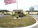 Community building with landscaping and American flag at 5448 Joy Ct, North Port, FL 34287