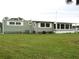 Single-story house with green siding and manicured lawn at 5448 Joy Ct, North Port, FL 34287