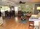 Open concept living and dining area with light wood floors and coastal decor at 5448 Joy Ct, North Port, FL 34287