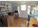 Sunlit home office with built-in shelving, desk, and a view of the backyard at 5448 Joy Ct, North Port, FL 34287