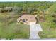 An aerial shot of a single-story house with a large yard and driveway at 5465 Trumpet St, North Port, FL 34291