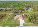 Aerial view of a single-Gathering house with a large yard and a screened pool at 5465 Trumpet St, North Port, FL 34291