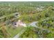 An aerial view showcasing a house, pool, shed, and surrounding landscape at 5465 Trumpet St, North Port, FL 34291