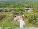 Aerial view showcasing a single Gathering home with a large yard and screened pool at 5465 Trumpet St, North Port, FL 34291