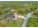 Aerial view of a house, pool, shed, and driveway, nestled in a lush green landscape at 5465 Trumpet St, North Port, FL 34291