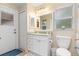 Simple bathroom with vanity, toilet, and exterior access at 5465 Trumpet St, North Port, FL 34291