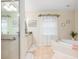 Spa-like bathroom with corner soaking tub and walk-in shower at 5465 Trumpet St, North Port, FL 34291