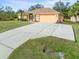 Large concrete driveway leading to a single-story house at 5465 Trumpet St, North Port, FL 34291