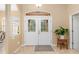 Bright and airy foyer with double doors and tile flooring at 5465 Trumpet St, North Port, FL 34291