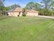 Single-story house with light peach exterior, solar panels, and a large yard at 5465 Trumpet St, North Port, FL 34291