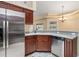 Kitchen with stainless steel appliances and wood cabinets at 5465 Trumpet St, North Port, FL 34291