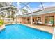 Relaxing pool area with screened enclosure at 5465 Trumpet St, North Port, FL 34291