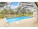 Screened pool and patio with lush landscaping at 5465 Trumpet St, North Port, FL 34291