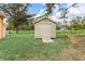 Tan storage shed with a ramp, located in a backyard setting at 5465 Trumpet St, North Port, FL 34291