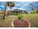 Landscaped backyard with pool and patio area at 594 Rotonda Cir, Rotonda West, FL 33947