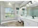 Double vanity bathroom with large shower and window at 594 Rotonda Cir, Rotonda West, FL 33947