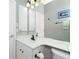 Bathroom with single vanity, toilet, and large mirror at 594 Rotonda Cir, Rotonda West, FL 33947