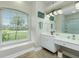 Double vanity bathroom with large shower and window at 594 Rotonda Cir, Rotonda West, FL 33947