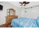 Bedroom with wood floors, dresser, and full bed at 594 Rotonda Cir, Rotonda West, FL 33947