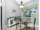 Bright breakfast nook features a table for four and garden view at 594 Rotonda Cir, Rotonda West, FL 33947