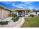 House front entry with teal double doors and walkway at 594 Rotonda Cir, Rotonda West, FL 33947