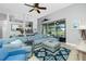 Bright and airy living room with sectional sofa and access to the pool area at 594 Rotonda Cir, Rotonda West, FL 33947