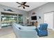 Relaxing living room with comfy seating, large TV, and sliding doors to pool area at 594 Rotonda Cir, Rotonda West, FL 33947