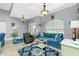 Inviting living room with a blue sofa, accent chair, and coastal decor at 594 Rotonda Cir, Rotonda West, FL 33947