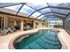 Large screened in pool with spa and comfortable seating at 594 Rotonda Cir, Rotonda West, FL 33947