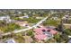 Aerial view of the house, highlighting the red tile roof, pool, and location within a neighborhood at 7148 & 7140 Coventry Ter, Englewood, FL 34224