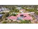 Aerial view of the house, highlighting the red tile roof, pool, and location within a neighborhood at 7148 & 7140 Coventry Ter, Englewood, FL 34224