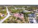 Aerial view of the house, highlighting the red tile roof, pool, and location within a neighborhood at 7148 & 7140 Coventry Ter, Englewood, FL 34224