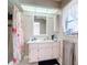 Floral-themed bathroom with shower and vanity at 7148 & 7140 Coventry Ter, Englewood, FL 34224