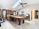 Game room with pool table, shelves, and skylight at 7148 & 7140 Coventry Ter, Englewood, FL 34224