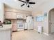 Clean kitchen with white appliances and wood cabinets at 7148 & 7140 Coventry Ter, Englewood, FL 34224