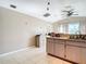 Kitchen features light wood cabinets and a breakfast bar at 7148 & 7140 Coventry Ter, Englewood, FL 34224