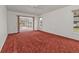 Main bedroom with red carpet and sliding glass doors to patio at 87 Torrington St, Port Charlotte, FL 33954