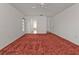 Spacious bedroom with red carpet and ceiling fan at 87 Torrington St, Port Charlotte, FL 33954