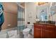 Updated bathroom with tub shower, wood vanity, and granite countertop at 89 Vivante Blvd # 205, Punta Gorda, FL 33950