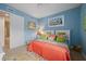 Bedroom with light blue walls, king bed, and coastal decor at 89 Vivante Blvd # 205, Punta Gorda, FL 33950