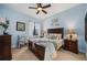 Bedroom with ceiling fan, king bed, and wood furniture at 89 Vivante Blvd # 205, Punta Gorda, FL 33950