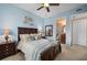 Bedroom with king bed, ensuite bathroom access, and coastal decor at 89 Vivante Blvd # 205, Punta Gorda, FL 33950