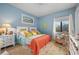 Bedroom with light blue walls, king bed, and coastal decor at 89 Vivante Blvd # 205, Punta Gorda, FL 33950