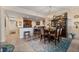 Elegant dining room with dark wood table and chairs, adjacent to kitchen at 89 Vivante Blvd # 205, Punta Gorda, FL 33950