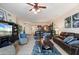 Living room with dark leather couches, a coffee table, and a view into the kitchen at 89 Vivante Blvd # 205, Punta Gorda, FL 33950